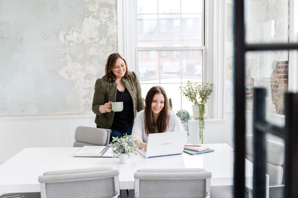 trebletree founders megan and lauren working on seo for yoga studios in trendy conference room