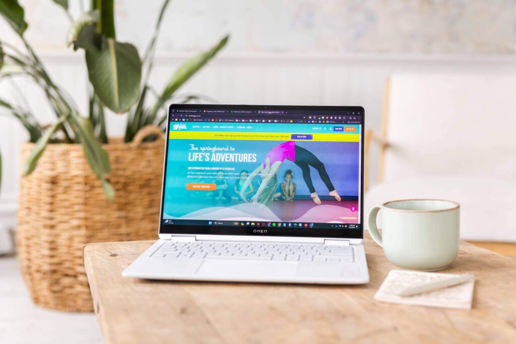 laptop on table showing the little gym website