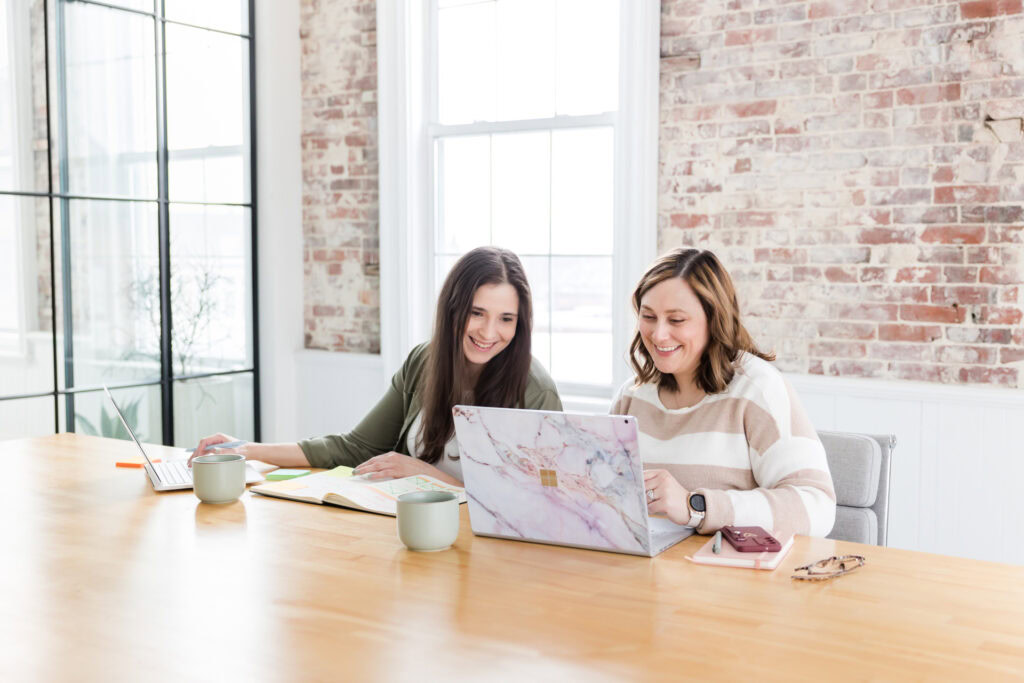 two woman looking at laptop reviewing google ai strategy