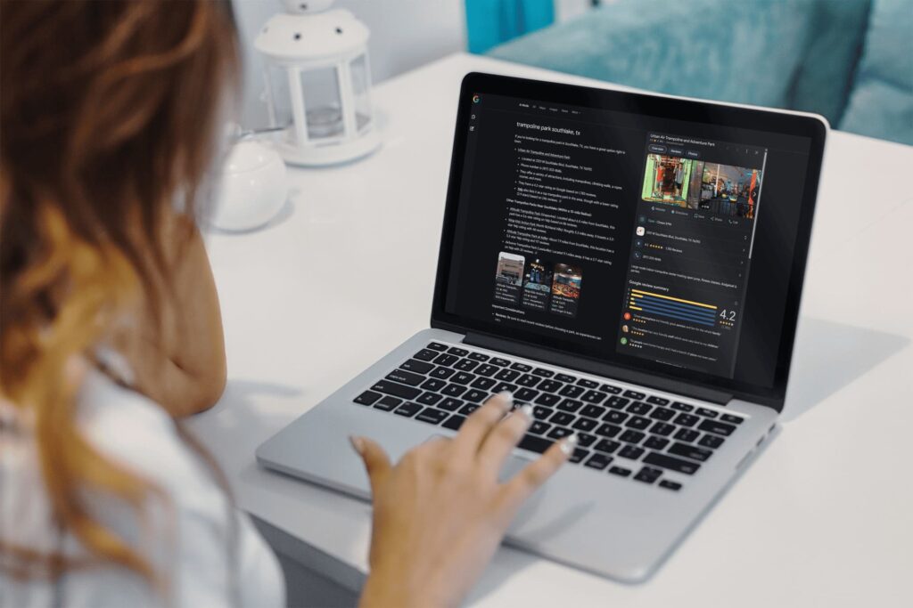 woman at laptop looking at new ai mode search results