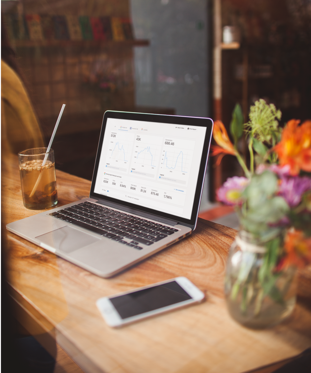 free-image-resizer-cropper digital ads analytics on laptop screen in rustic coffee shop