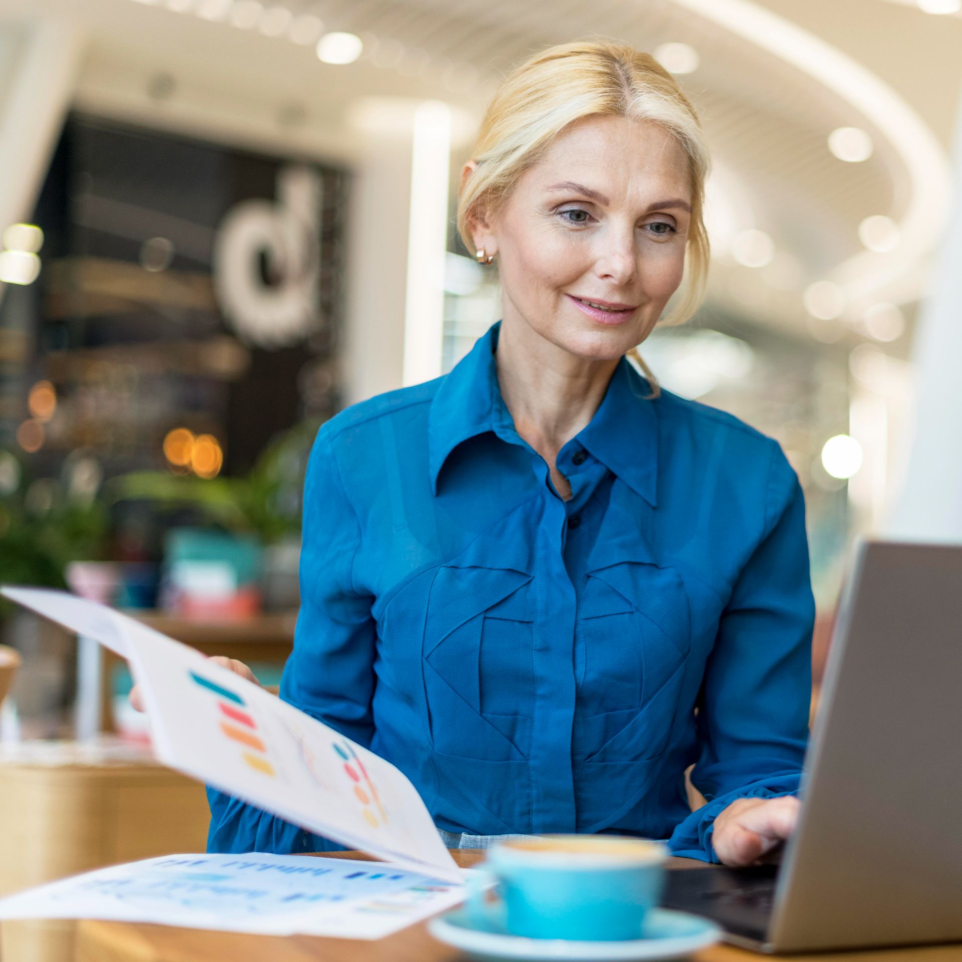 front-view-elder-business-woman-working-laptop-with-coffee-papers