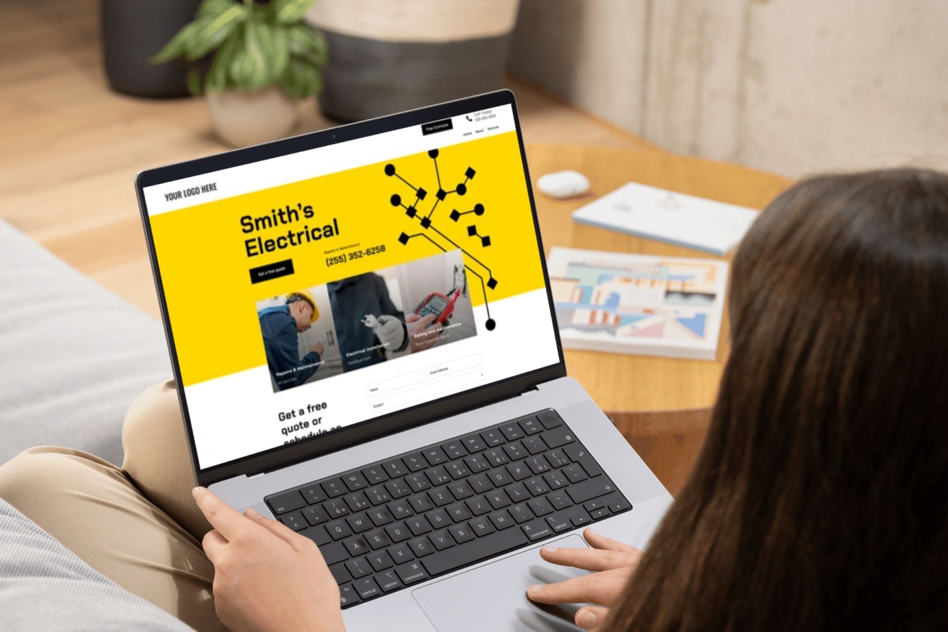 woman looking at website for electrician on laptop