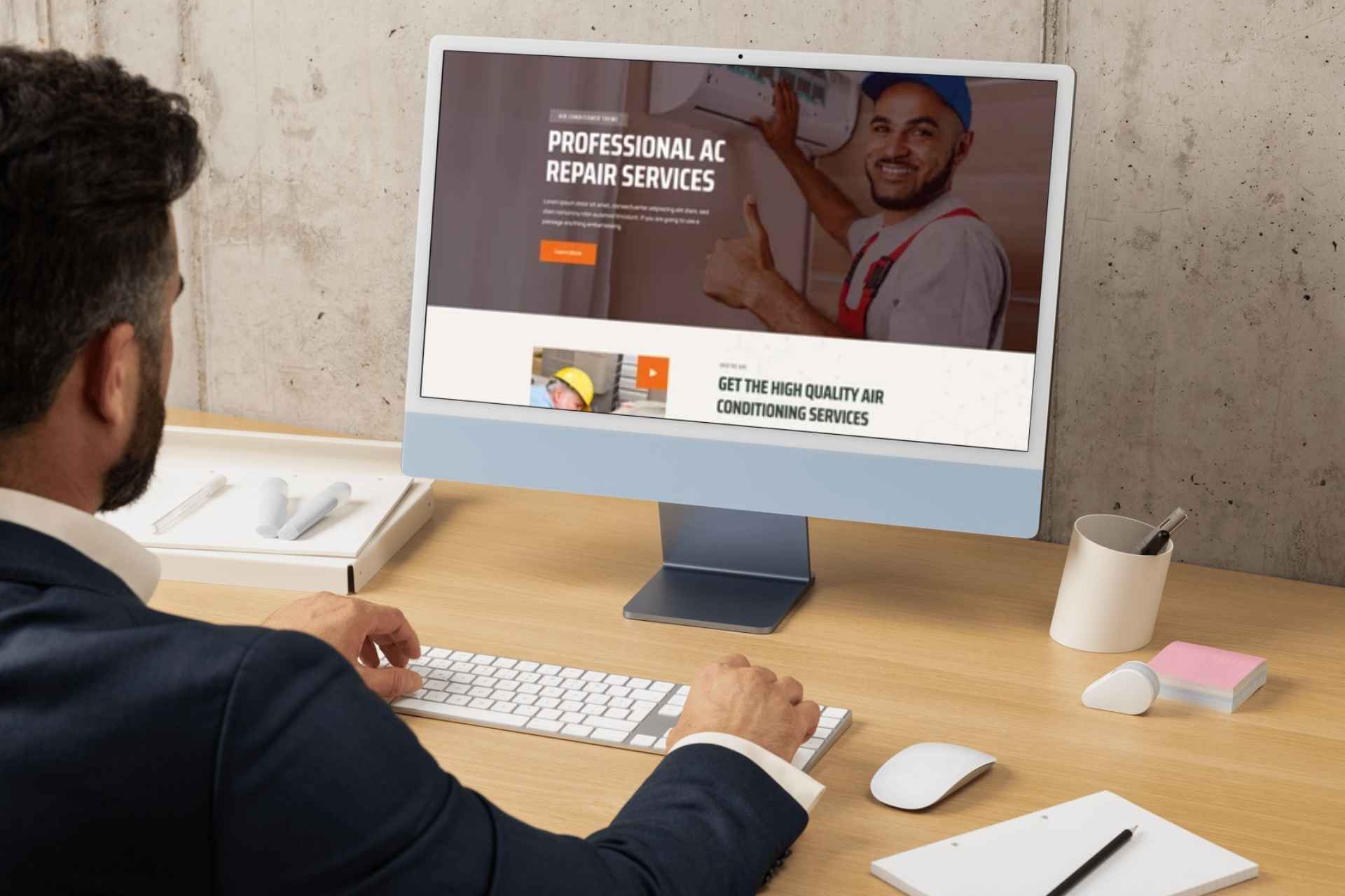 man looking at a computer screen with a professional HVAC website