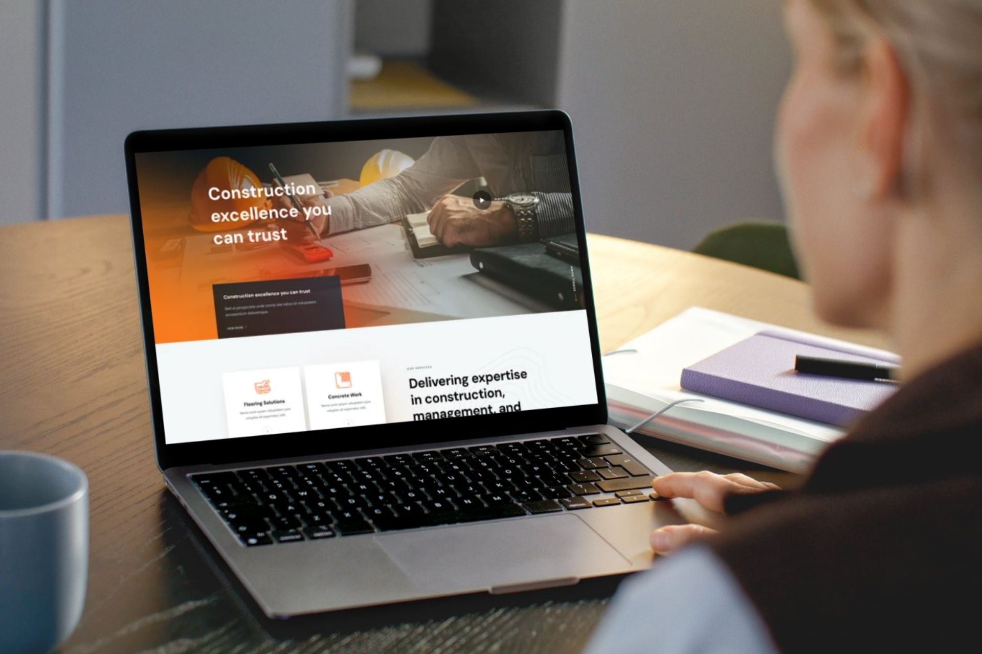 woman looking at a construction website on laptop