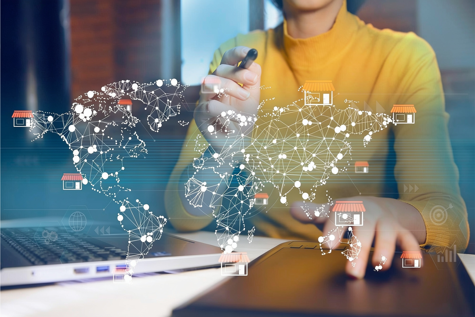 professional woman at desk with overlay of connected world map representing franchise networks