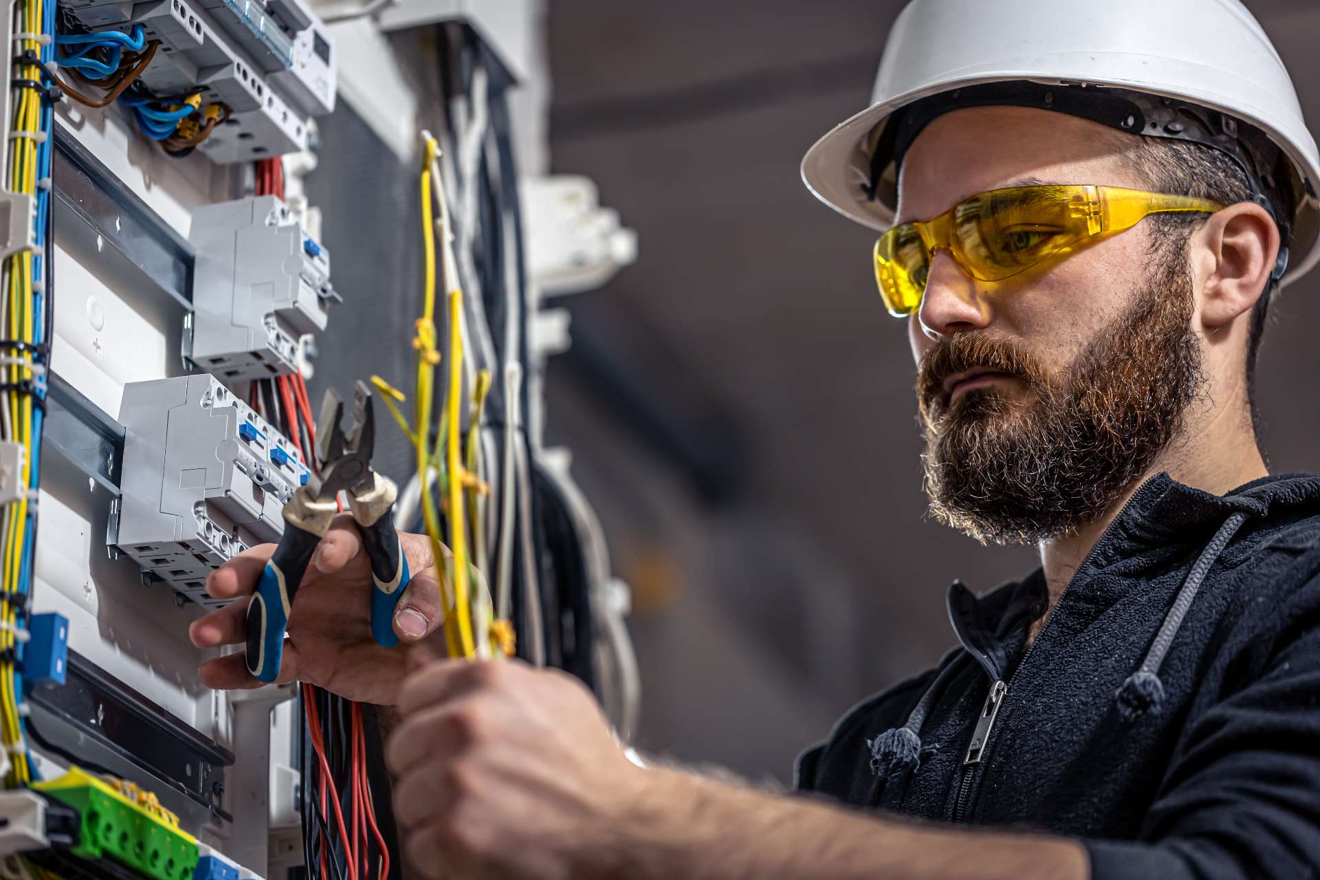 male electrician working on a switchboard