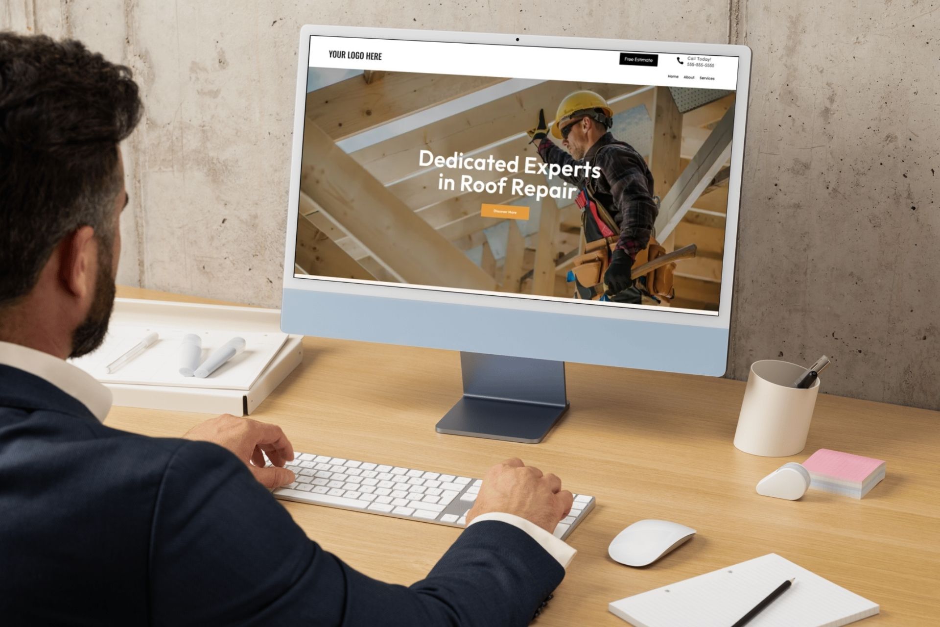 man at desk looking at roofing website on screen