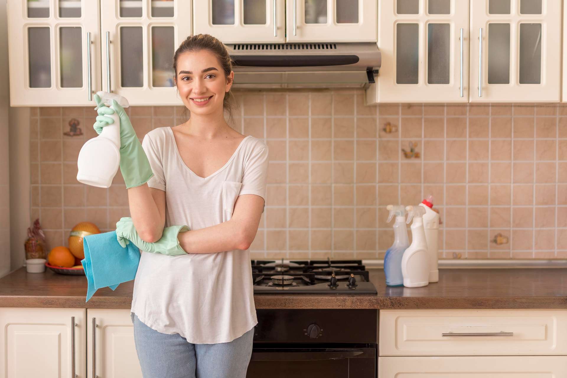 cleaning company owner standing in kitchen with supplies