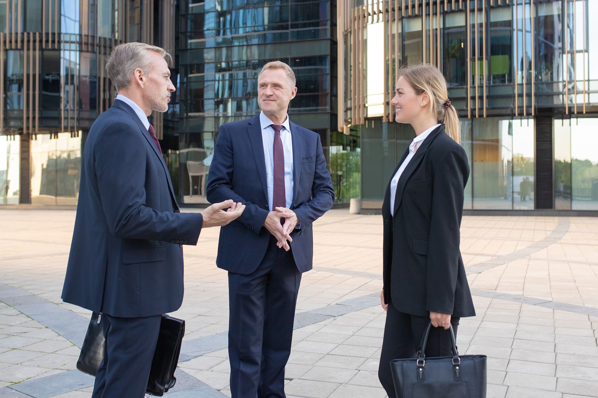 lawyers having a discussion outside a urban courthouse 