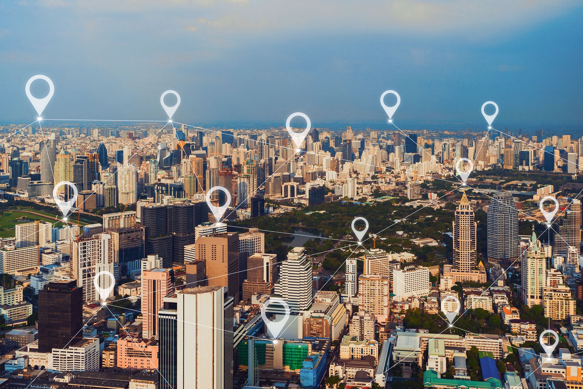 aerial view of a city with map pins representing a multi-location business