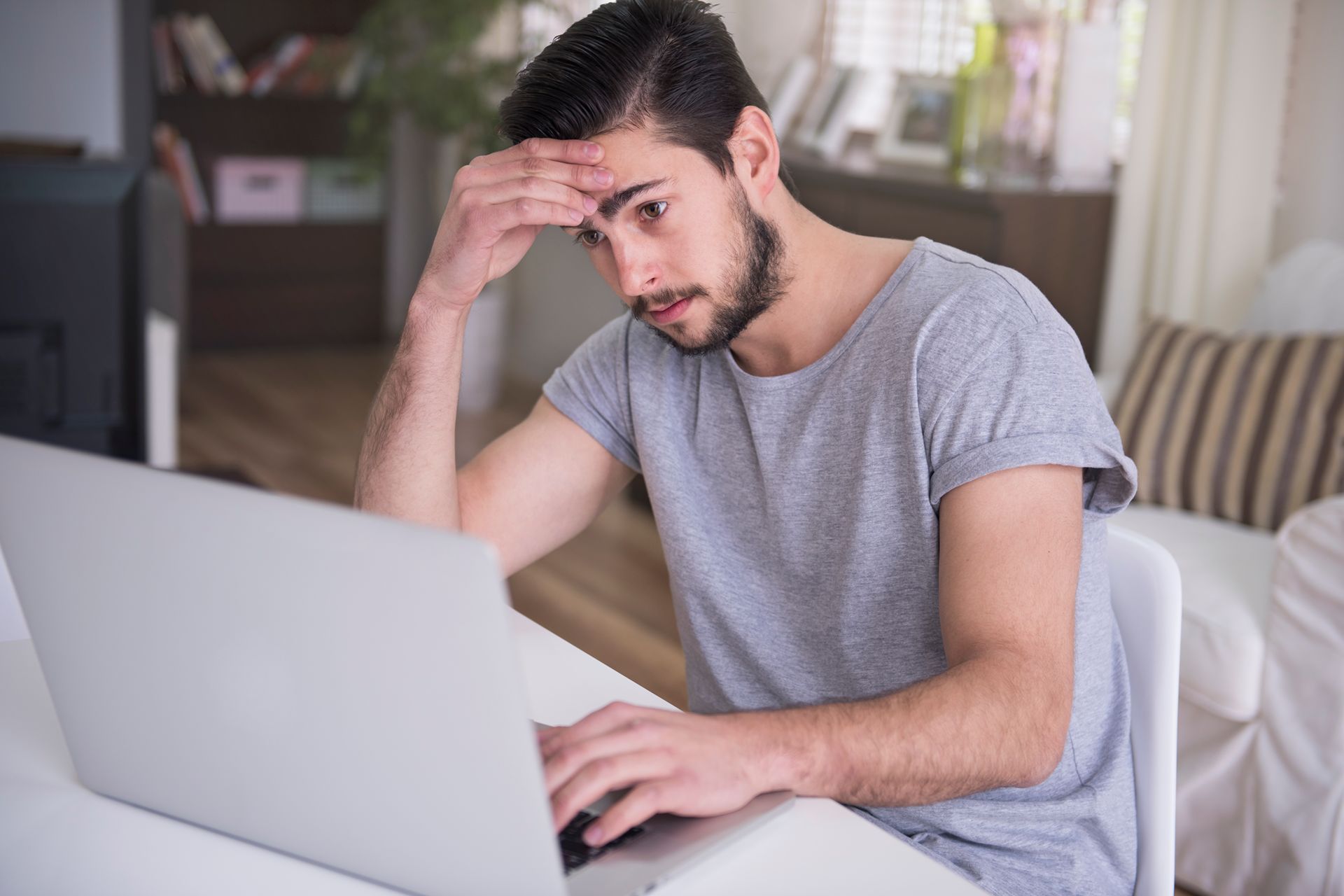 stressed man searching online for chiropractor
