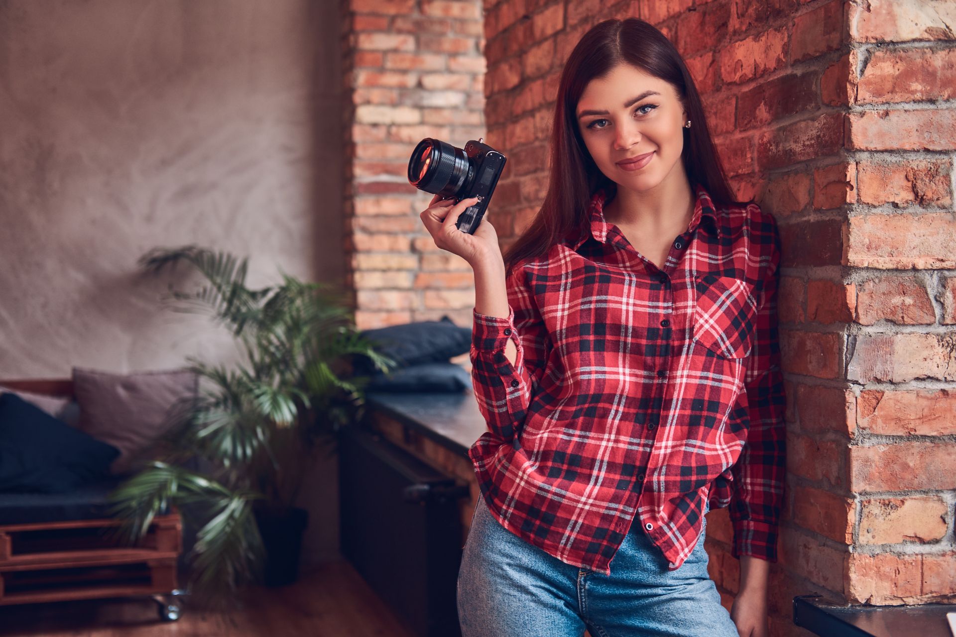 young female photographer posing with her camera