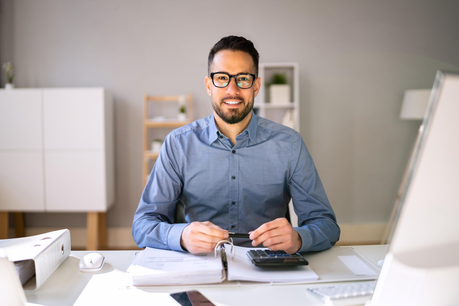 man sitting at desk representing a nh local business owner working