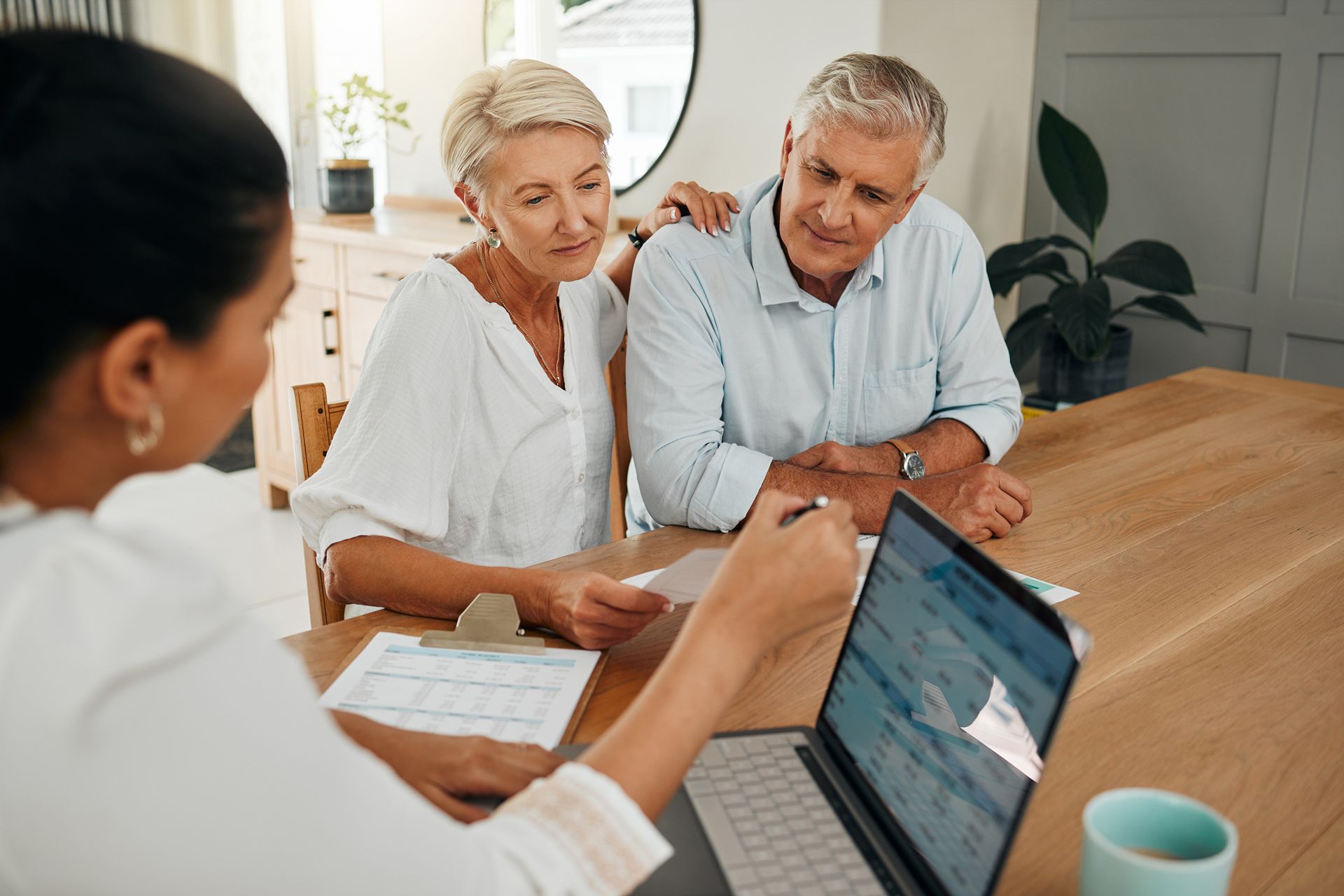 older couple reviews documents with their financial planner
