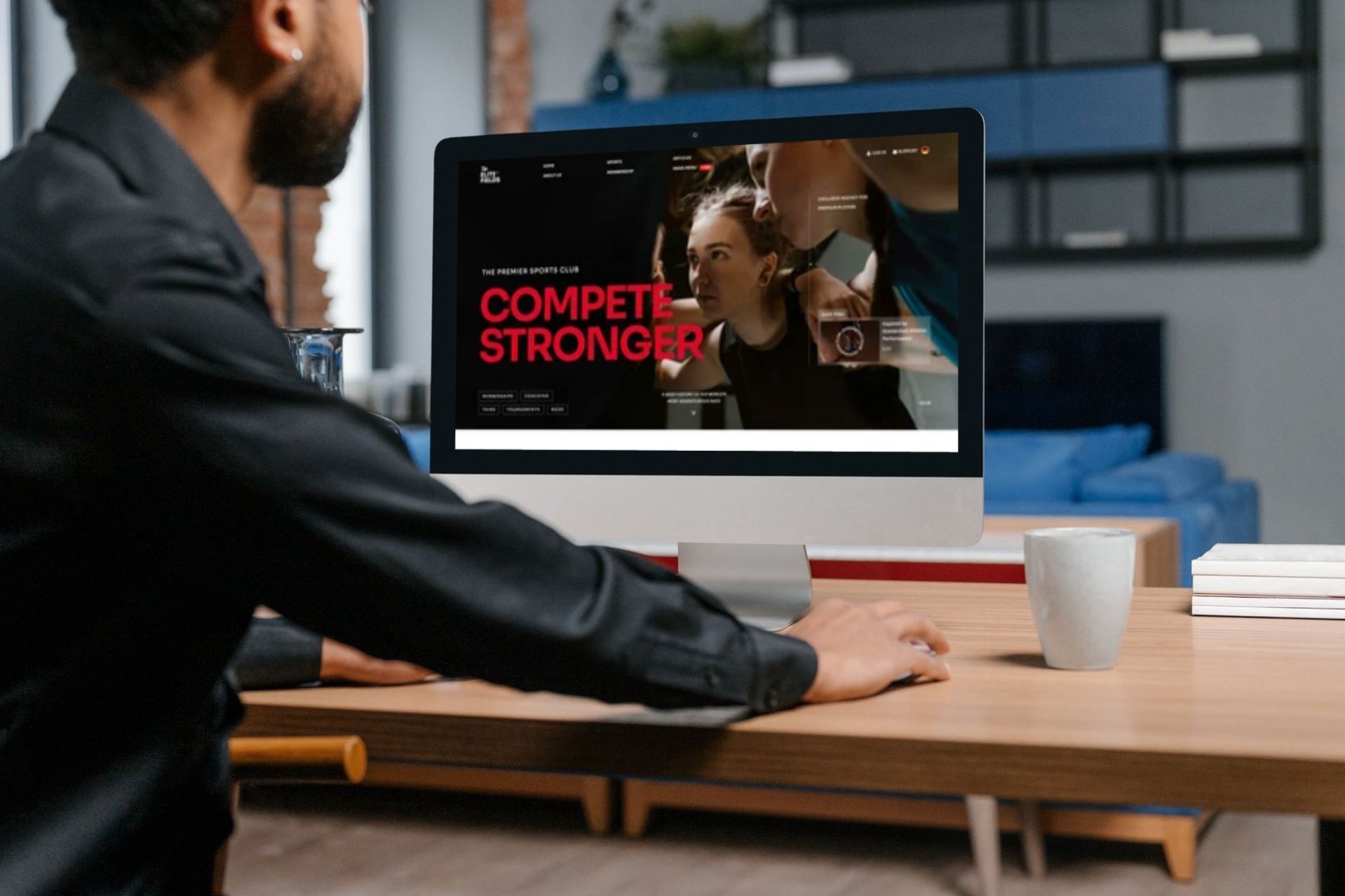 Man looks at a computer screen showing a sample personal trainer website