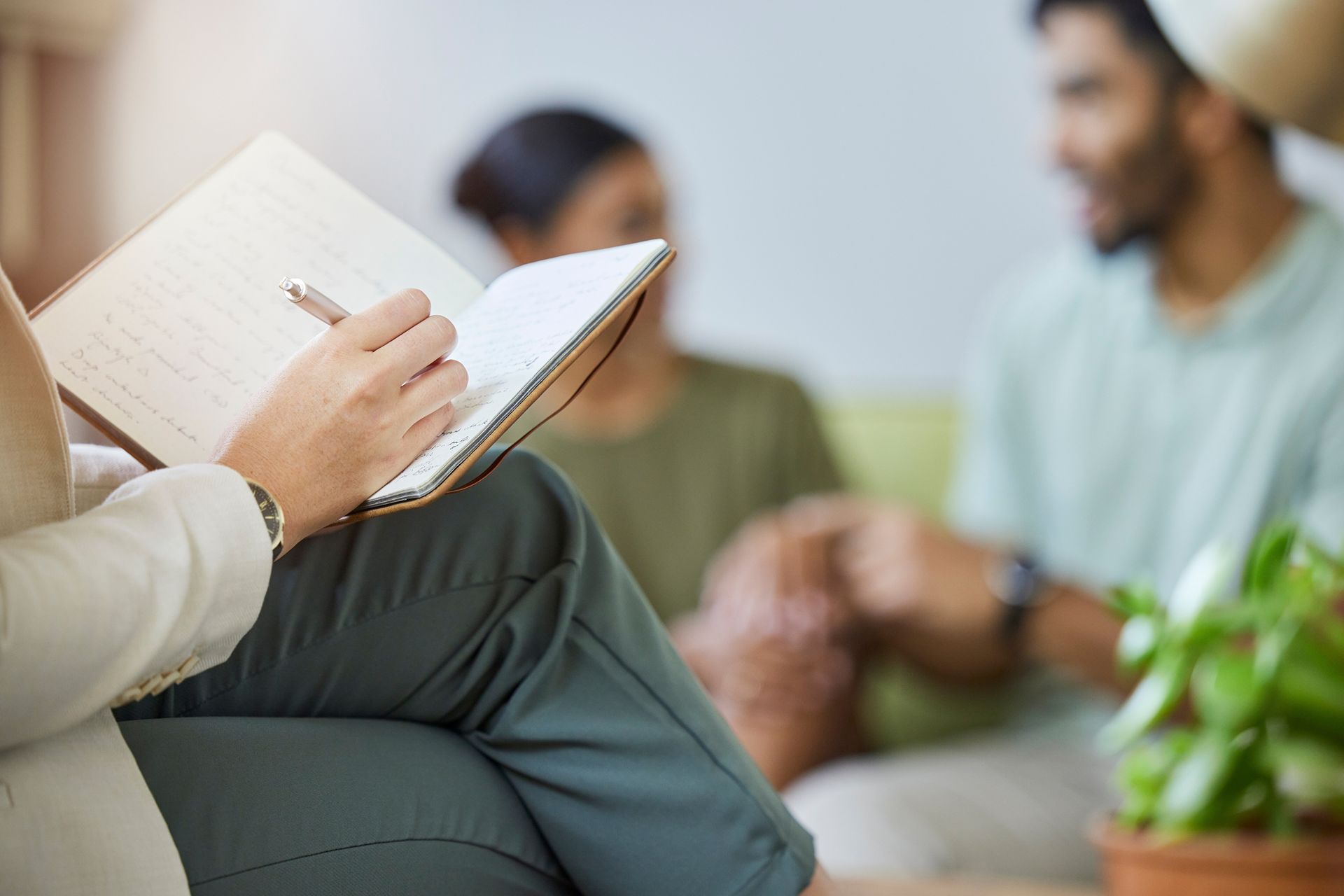 close up of therapist notebook with patient in background