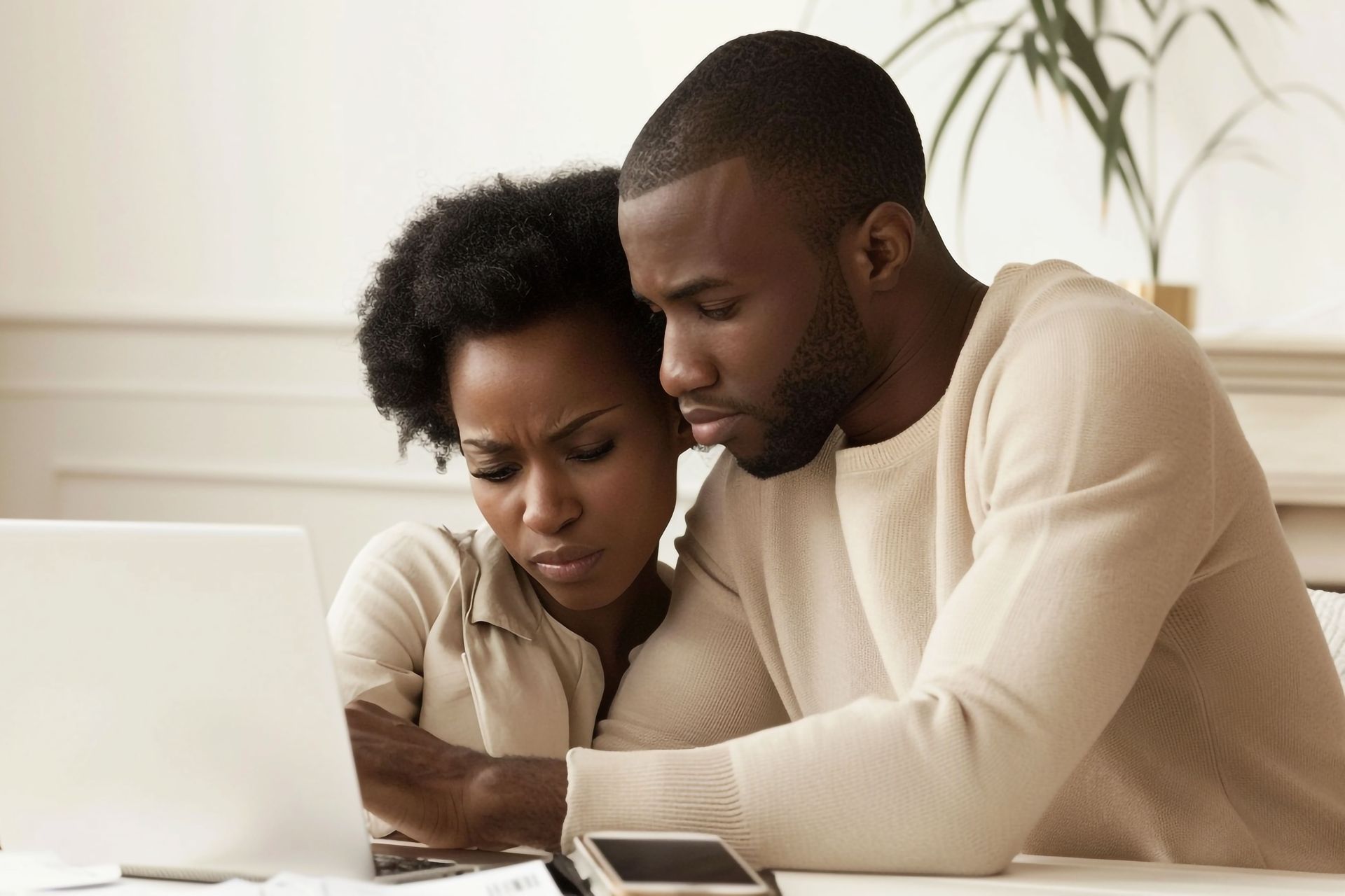 concerned couple searching online for a therapist