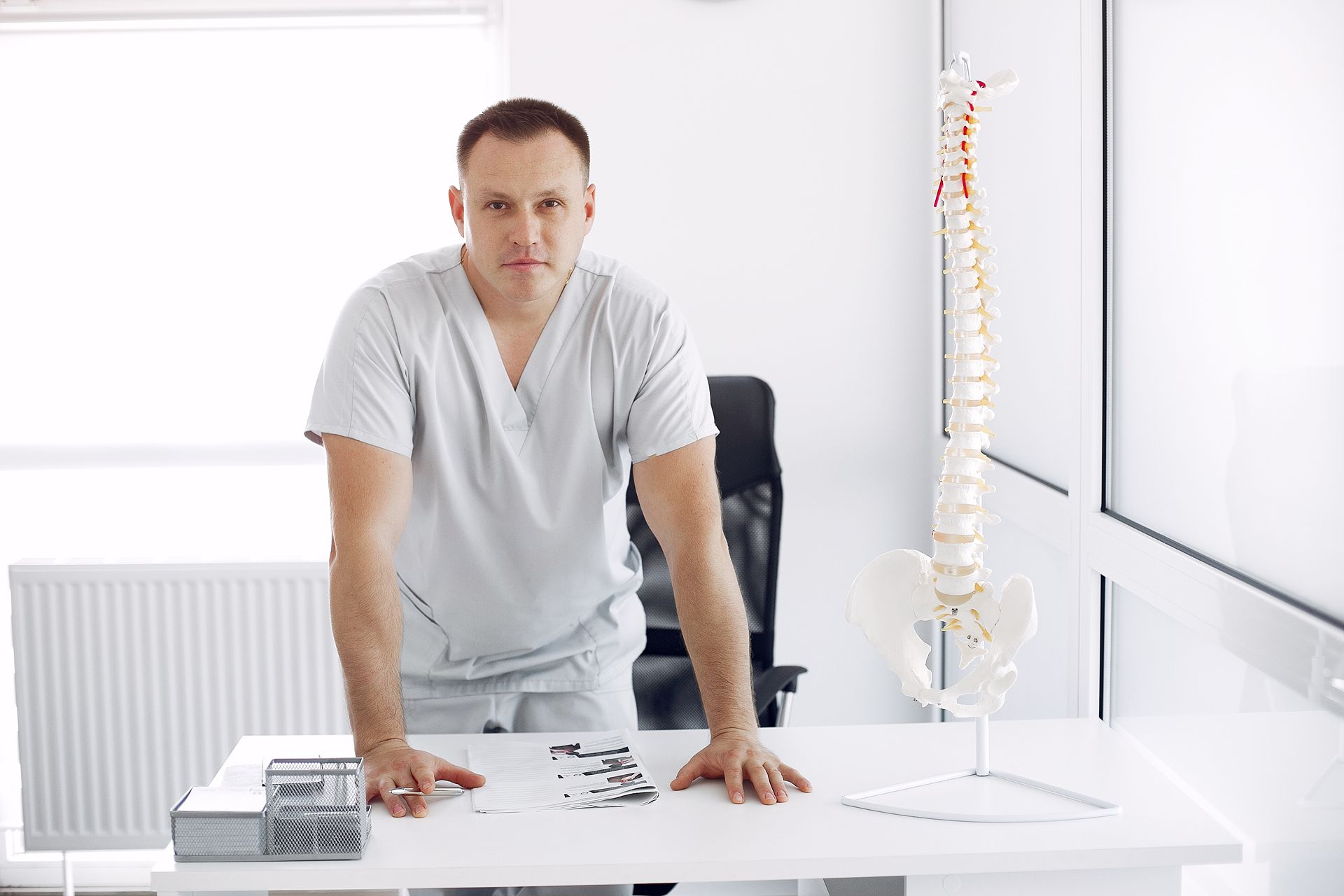 chiropractor standing at his desk determined to work on his digital marketing