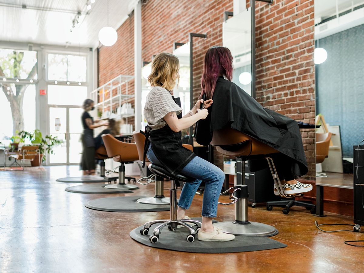 woman cutting hair in a stylish hair salon