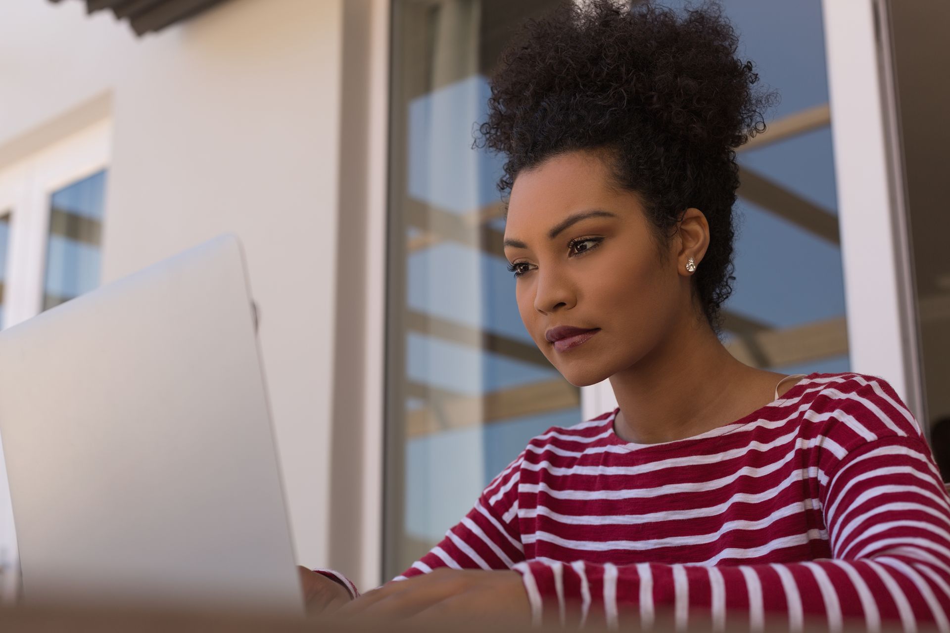 woman with serious expression looking online for a health coach
