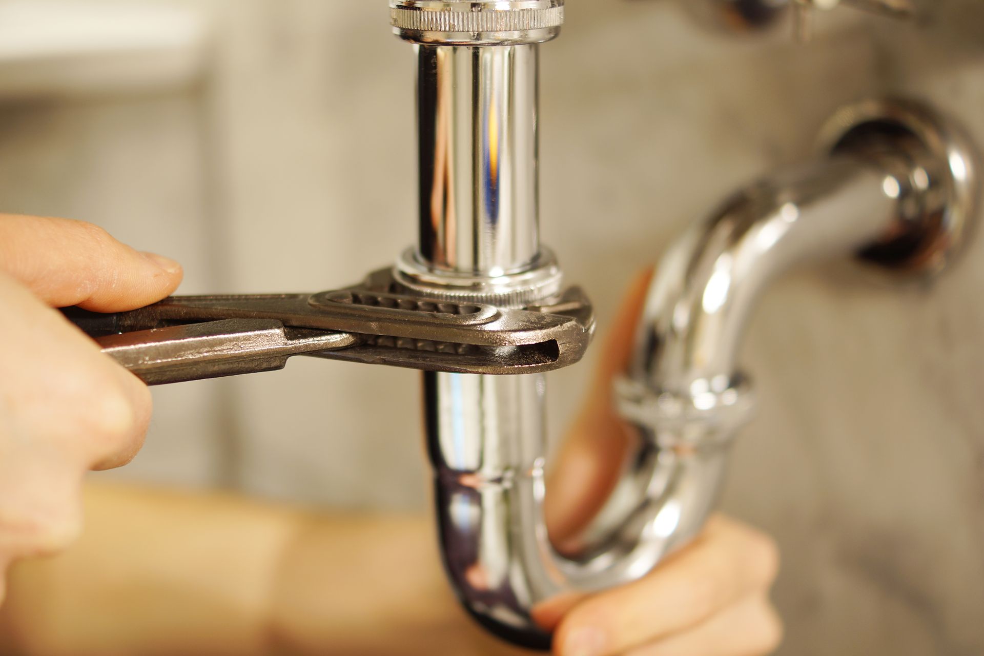 close up of plumber fixing pipe